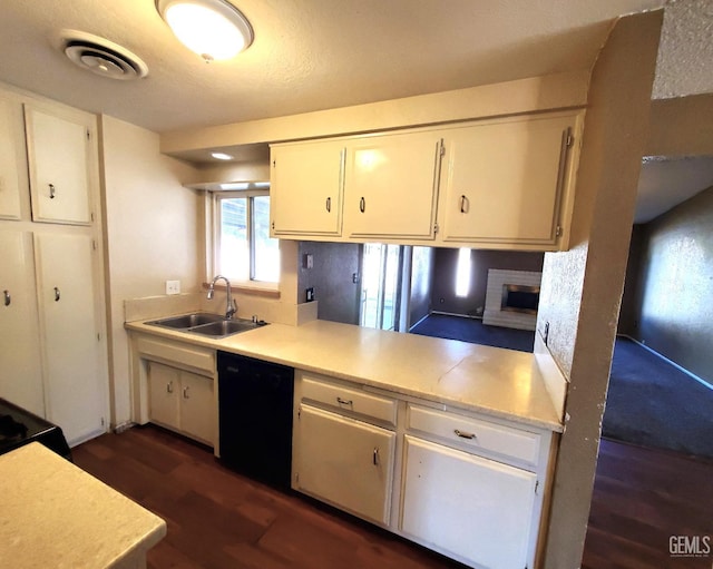 4204 Tyndall Ave, Bakersfield, CA 93313 - kitchen featuring black dishwasher, dark wood-style floors, white cabinets, and light countertops