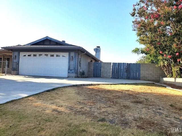 4204 Tyndall Ave, Bakersfield, CA 93313 - view of front of property with a gate, an attached garage, concrete driveway, and a chimney