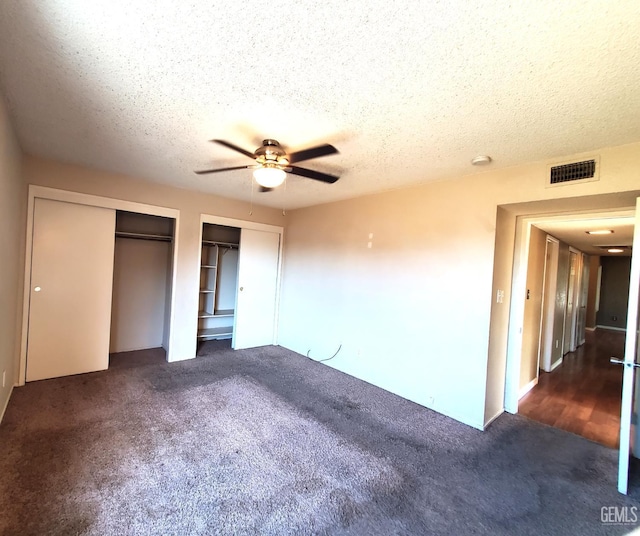 4204 Tyndall Ave, Bakersfield, CA 93313 - unfurnished bedroom with multiple closets, carpet floors, a textured ceiling, and a ceiling fan