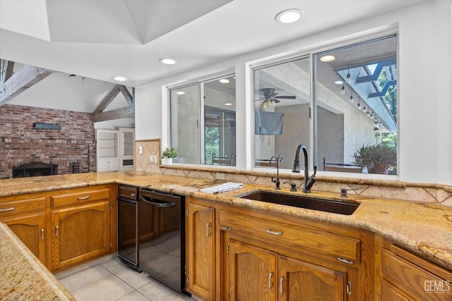 11717 Old Town Rd, Bakersfield, CA 93312 - kitchen featuring light tile patterned floors, brown cabinetry, light stone countertops, a fireplace, and recessed lighting