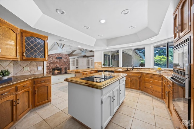 11717 Old Town Rd, Bakersfield, CA 93312 - kitchen featuring black electric stovetop, backsplash, light tile patterned floors, a kitchen island, and recessed lighting