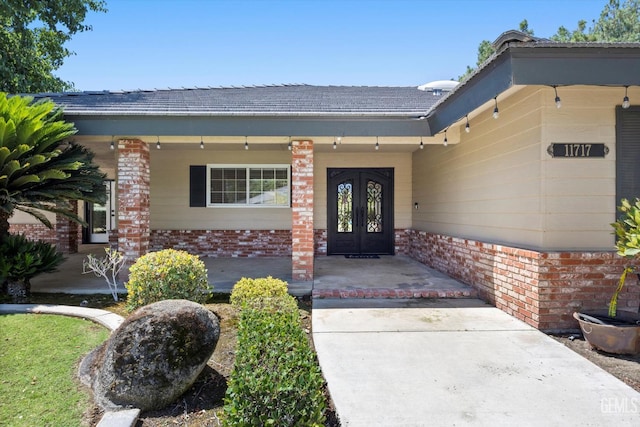 11717 Old Town Rd, Bakersfield, CA 93312 - entrance to property featuring brick siding, a porch, and french doors