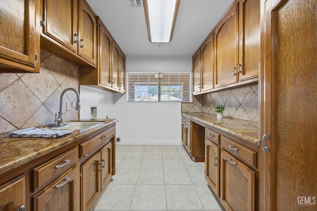 11717 Old Town Rd, Bakersfield, CA 93312 - kitchen with brown cabinets, backsplash, and stone counters