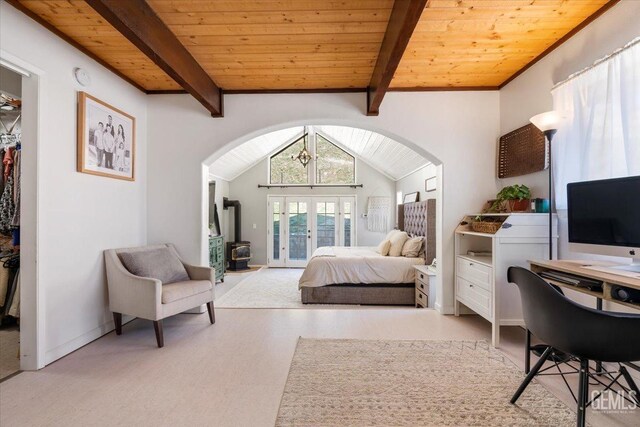 bedroom featuring vaulted ceiling with beams, wood ceiling, baseboards, a spacious closet, and french doors