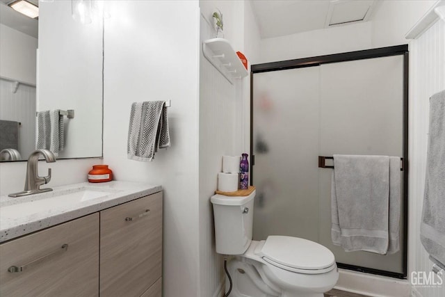 full bathroom with a stall shower, vanity, and toilet