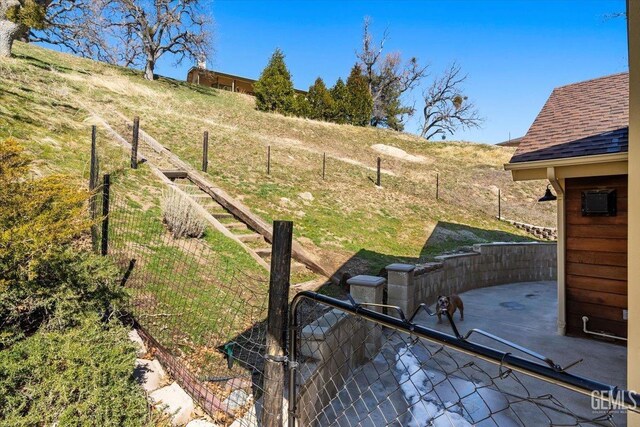 view of yard featuring fence and a patio