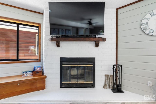 interior details featuring wooden walls, a brick fireplace, and a textured ceiling