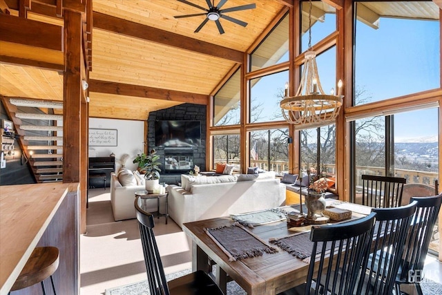 sunroom / solarium featuring wooden ceiling, lofted ceiling with beams, and ceiling fan with notable chandelier