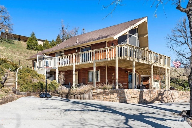 view of front of home with stairway and a deck