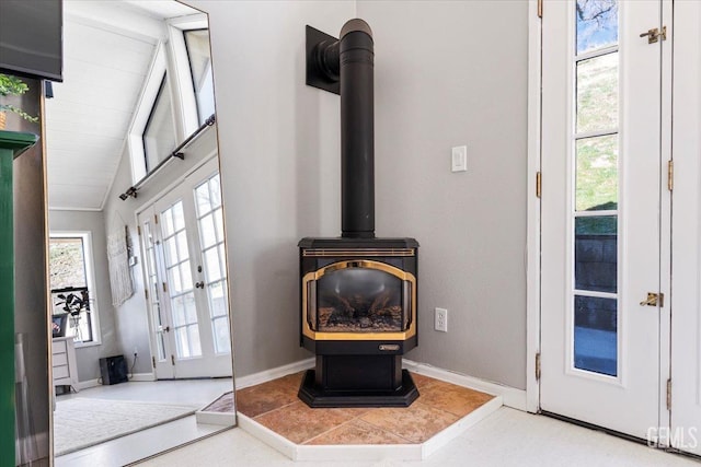 room details featuring a wood stove and baseboards