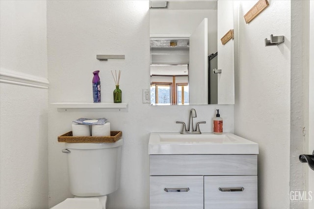 bathroom with vanity and toilet