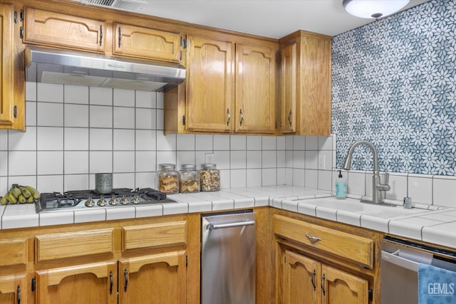 9913 Mark Twain Ave, Bakersfield, CA 93312 - kitchen featuring under cabinet range hood, stainless steel appliances, decorative backsplash, and light countertops