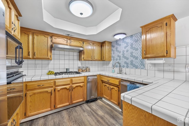 9913 Mark Twain Ave, Bakersfield, CA 93312 - kitchen featuring a raised ceiling, black microwave, dark wood-style flooring, gas cooktop, and backsplash