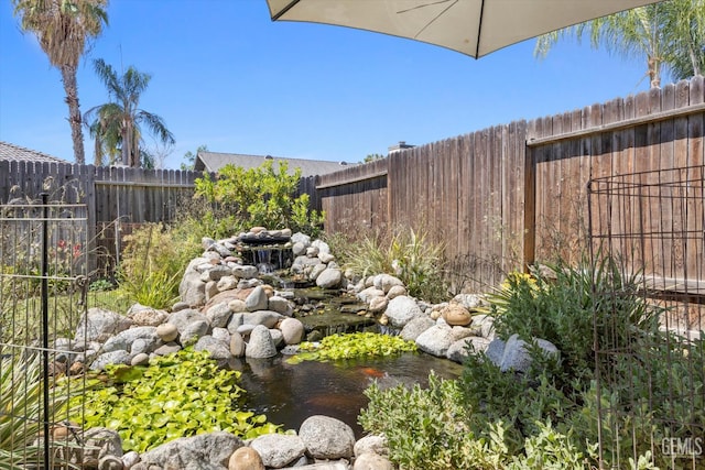 9913 Mark Twain Ave, Bakersfield, CA 93312 - fenced backyard with a small pond
