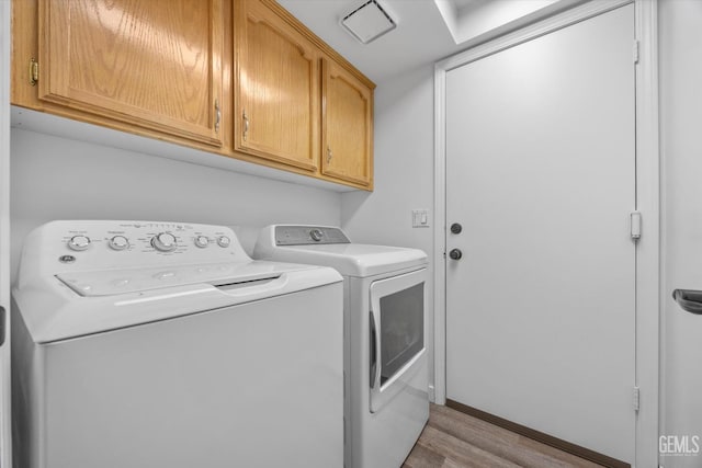 9913 Mark Twain Ave, Bakersfield, CA 93312 - laundry room featuring cabinet space, independent washer and dryer, and light wood-type flooring