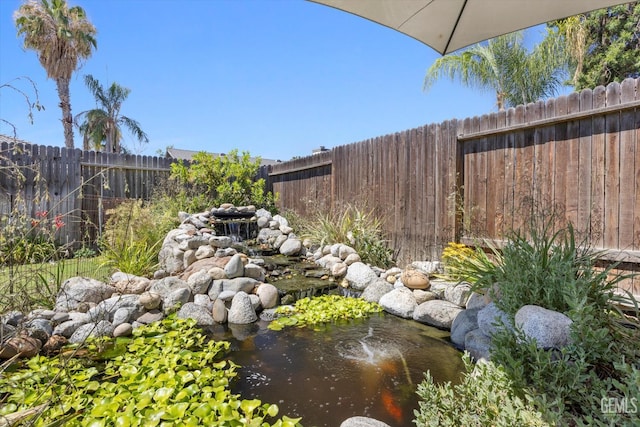 9913 Mark Twain Ave, Bakersfield, CA 93312 - fenced backyard featuring a small pond