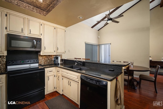 kitchen featuring a sink, a peninsula, black appliances, dark wood-type flooring, and ceiling fan