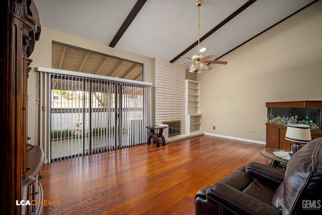 living room with baseboards, ceiling fan, built in features, wood finished floors, and beam ceiling