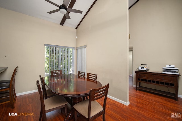 dining area featuring baseboards, high vaulted ceiling, a ceiling fan, and wood finished floors