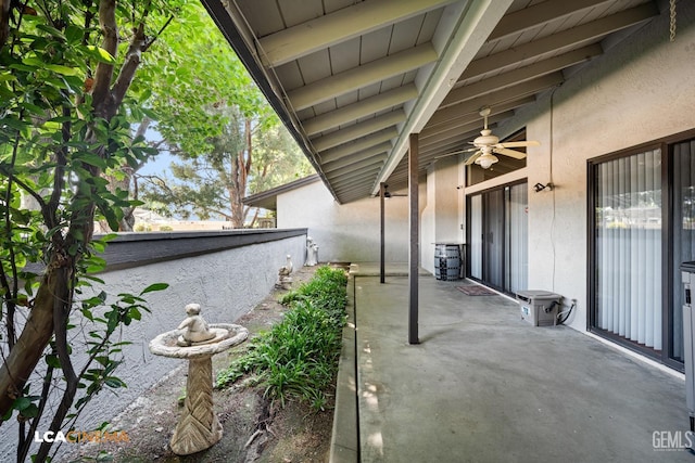 view of patio / terrace with fence and a ceiling fan