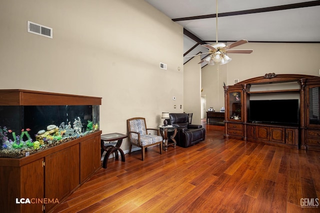 living area with visible vents, wood finished floors, and a ceiling fan