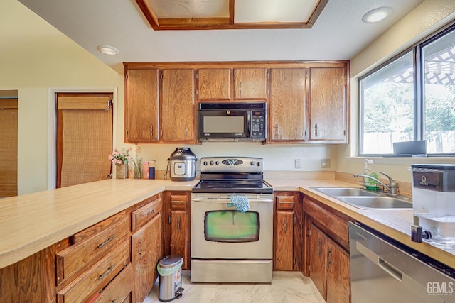 6901 Shelby Loop, Bakersfield, CA 93309 - kitchen with stainless steel appliances, light countertops, light marble finish floors, and brown cabinets