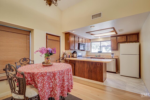 6901 Shelby Loop, Bakersfield, CA 93309 - kitchen with freestanding refrigerator, black microwave, stainless steel dishwasher, range, and a peninsula