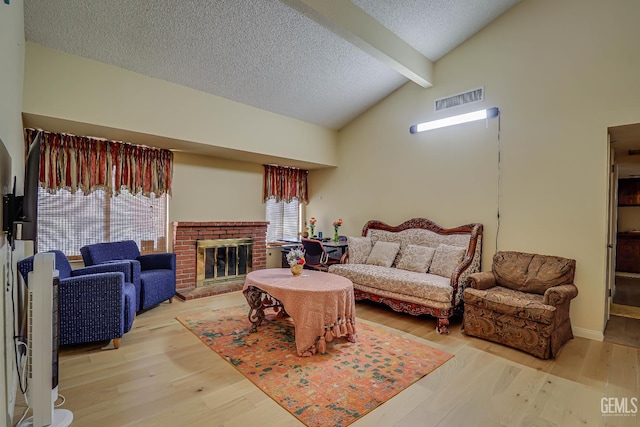 6901 Shelby Loop, Bakersfield, CA 93309 - living room with a textured ceiling, wood finished floors, and a brick fireplace