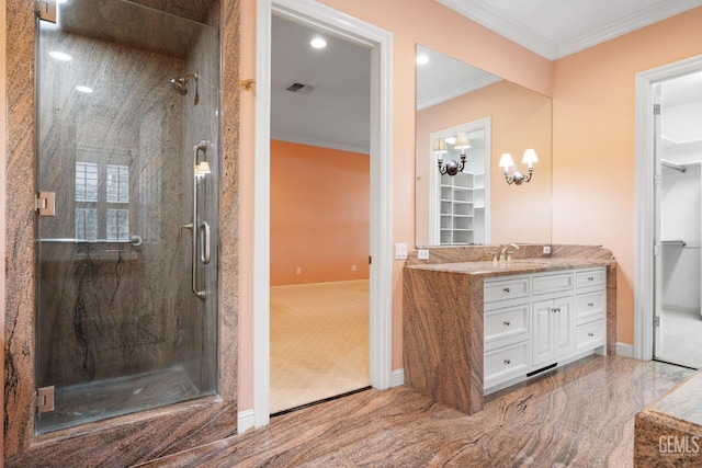 bathroom with an enclosed shower, vanity, and crown molding