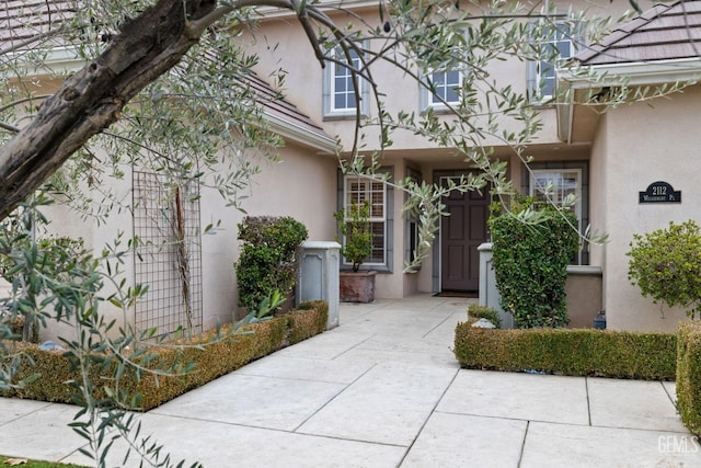 property entrance featuring a patio