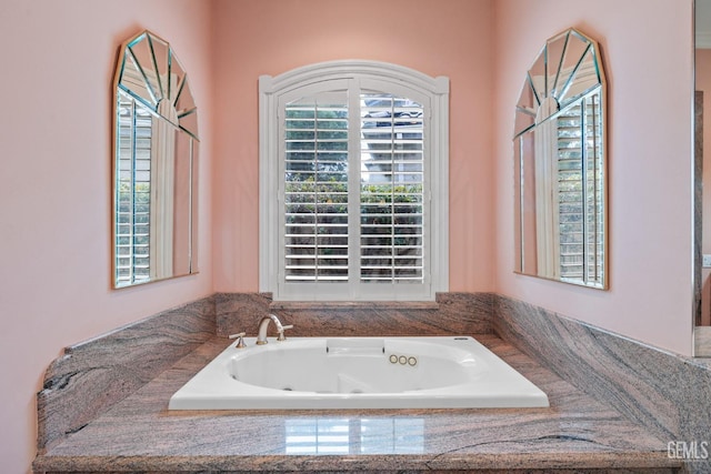 bathroom with a relaxing tiled tub