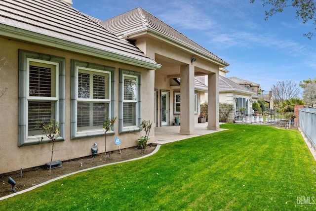 rear view of house with a patio and a yard