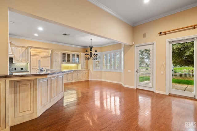 kitchen with an inviting chandelier, decorative light fixtures, plenty of natural light, and light wood-type flooring