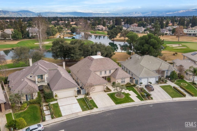 aerial view featuring a water and mountain view