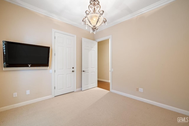 unfurnished bedroom featuring an inviting chandelier, crown molding, and carpet