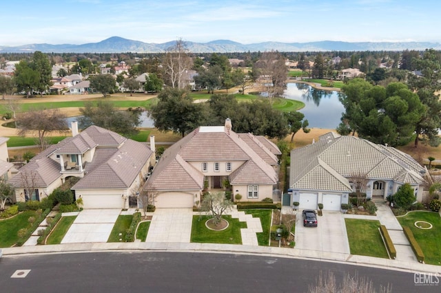 drone / aerial view with a water and mountain view