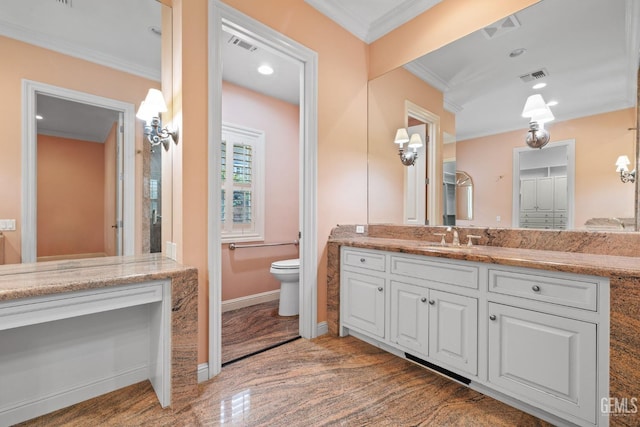 bathroom with ornamental molding, wood-type flooring, vanity, and toilet