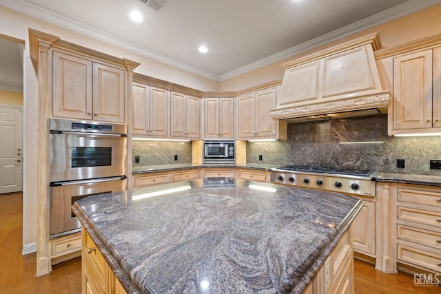 kitchen featuring premium range hood, appliances with stainless steel finishes, a center island, and light brown cabinetry