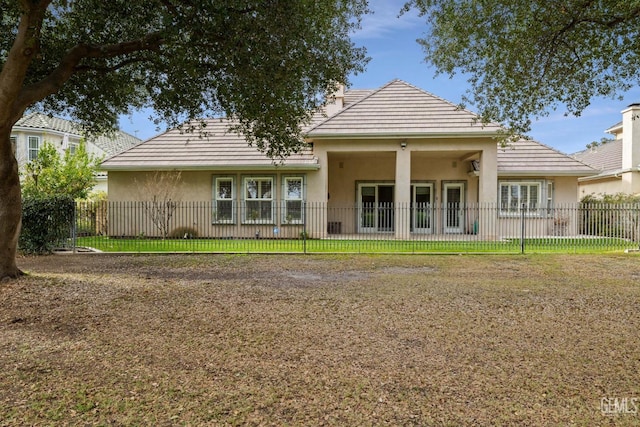 rear view of property featuring a yard