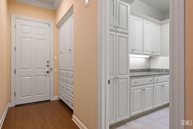 hall with crown molding and light wood-type flooring