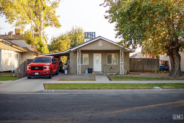 view of front of property featuring a carport