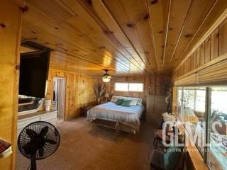 bedroom featuring wood walls, carpet floors, and wood ceiling