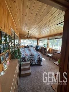 interior space featuring carpet, ceiling fan, and wooden ceiling