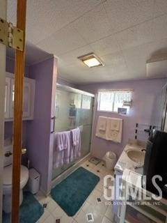 bathroom with vanity, a shower with shower door, and toilet