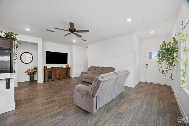 living room with ceiling fan and dark hardwood / wood-style flooring