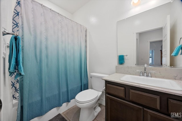 full bathroom featuring tile patterned floors, vanity, toilet, and shower / bath combo with shower curtain