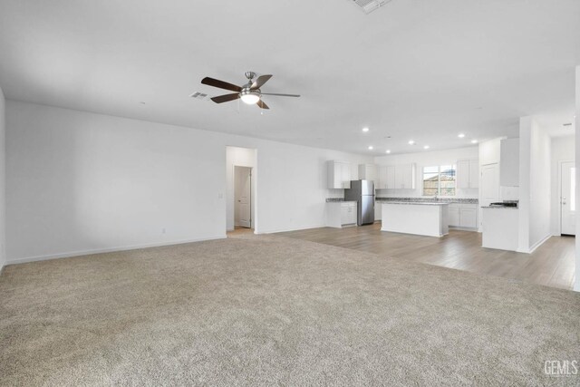 4912 Beaverhead Ave, Bakersfield, CA 93306 - unfurnished living room featuring light colored carpet, ceiling fan, and recessed lighting