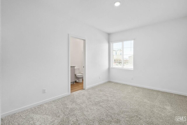 4912 Beaverhead Ave, Bakersfield, CA 93306 - unfurnished bedroom featuring light colored carpet, ensuite bath, and recessed lighting