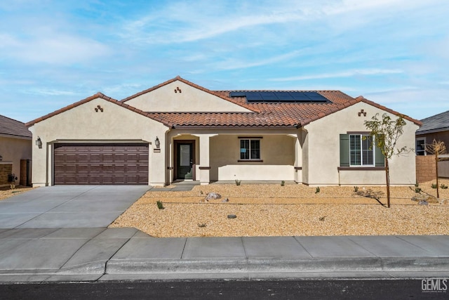 4912 Beaverhead Ave, Bakersfield, CA 93306 - mediterranean / spanish-style home with stucco siding, a garage, a tiled roof, and concrete driveway