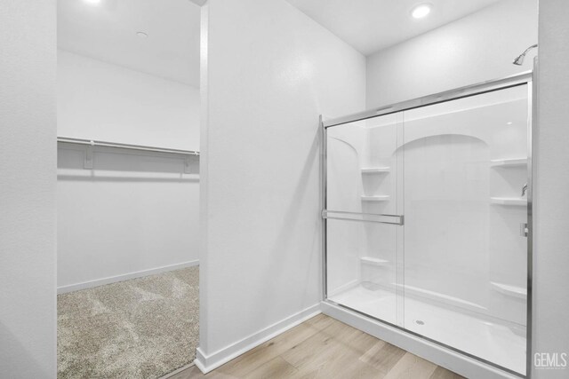 4912 Beaverhead Ave, Bakersfield, CA 93306 - full bathroom with a shower stall, a spacious closet, wood finished floors, and recessed lighting